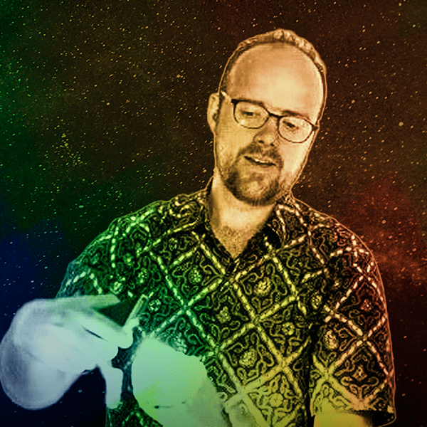 Charles Matthews. Charles is a light-skinned, early forties man, wearing a detailed pattern button-up shirt with short hair, light beard, and medium-thick framed glasses. Image is treated with a rainbow overlay to match the album artwork.
